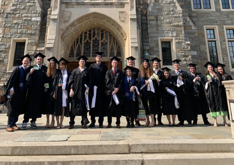 CERES graduates gather in front of White Gravenor in caps and gowns to celebrate graduation