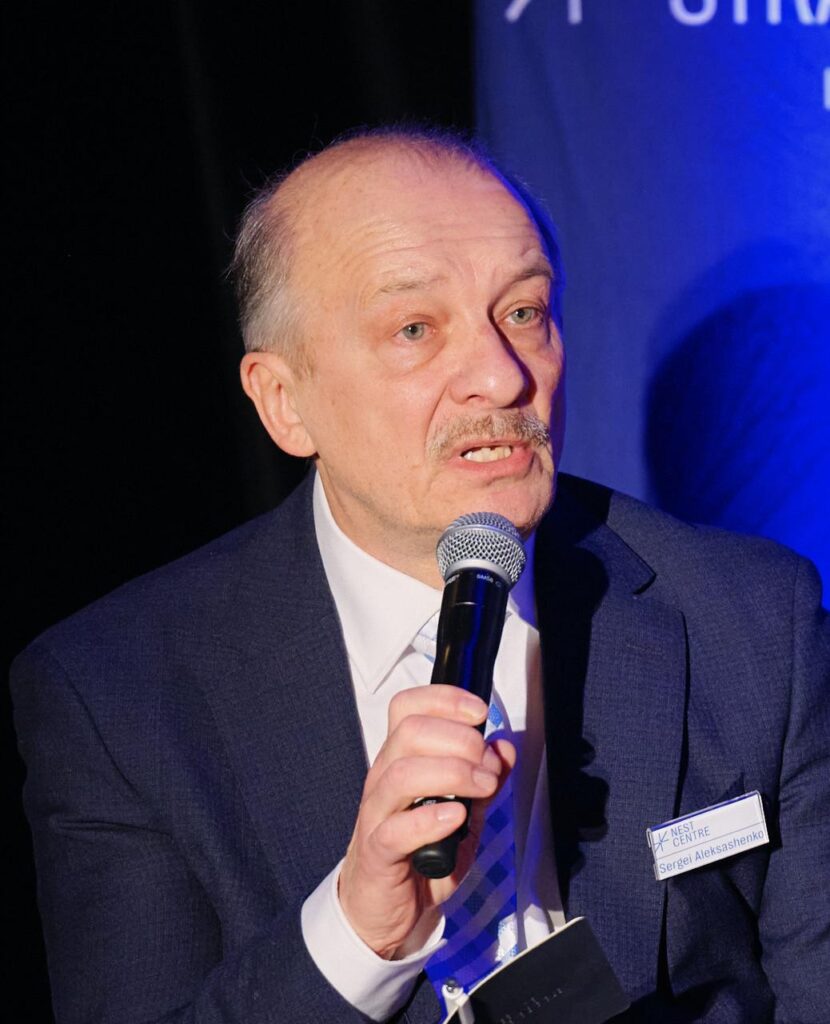 Sergey Aleksashenko speaking into a microphone