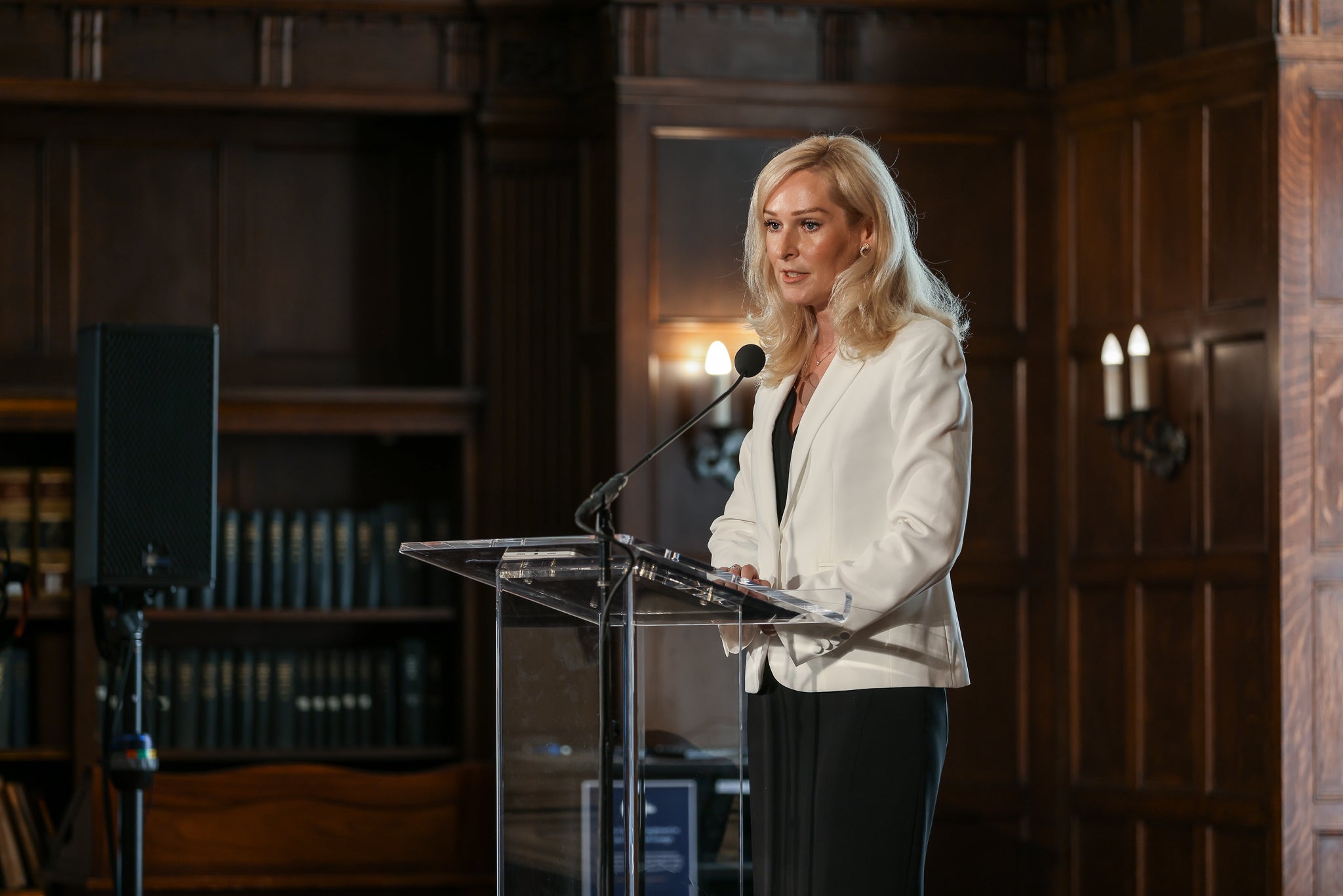 Anastasia Popova speaking at a podium
